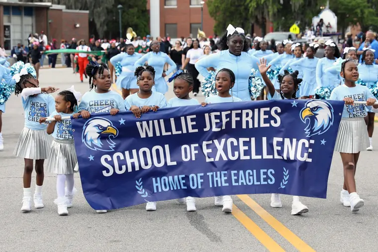 Youth cheerleaders marching in the Homecoming Parade