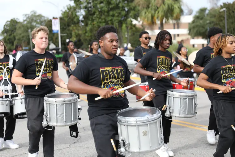 A drumline performing along the Homecoming parade route